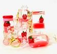 Strawberry Floaty KeyChain with playful floating strawberry design in assorted clear colorful shapes and gold key rings.