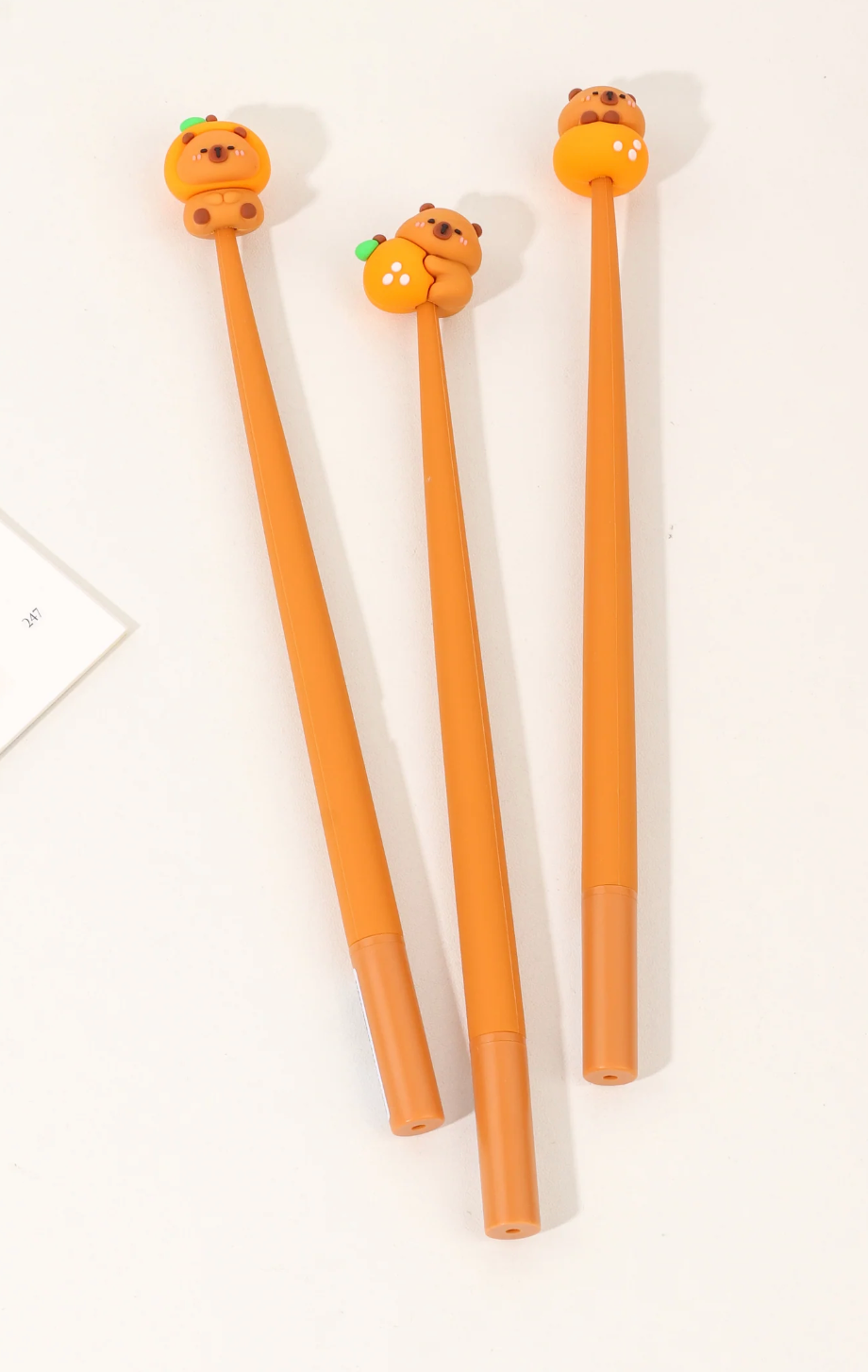 Capybara Wiggle Gel Pen set with playful orange capybara toppers for smooth, fun writing experience.