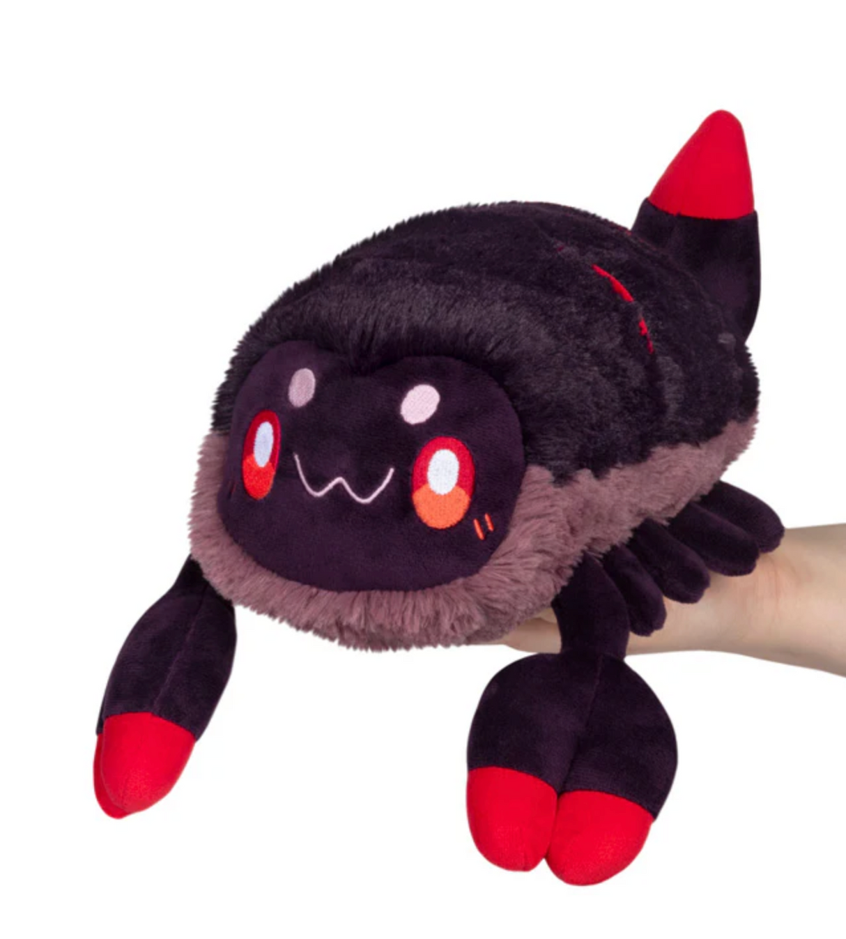 Scorpion Mini plushie with a cute smiling face, soft black and red design held by a hand on white background.