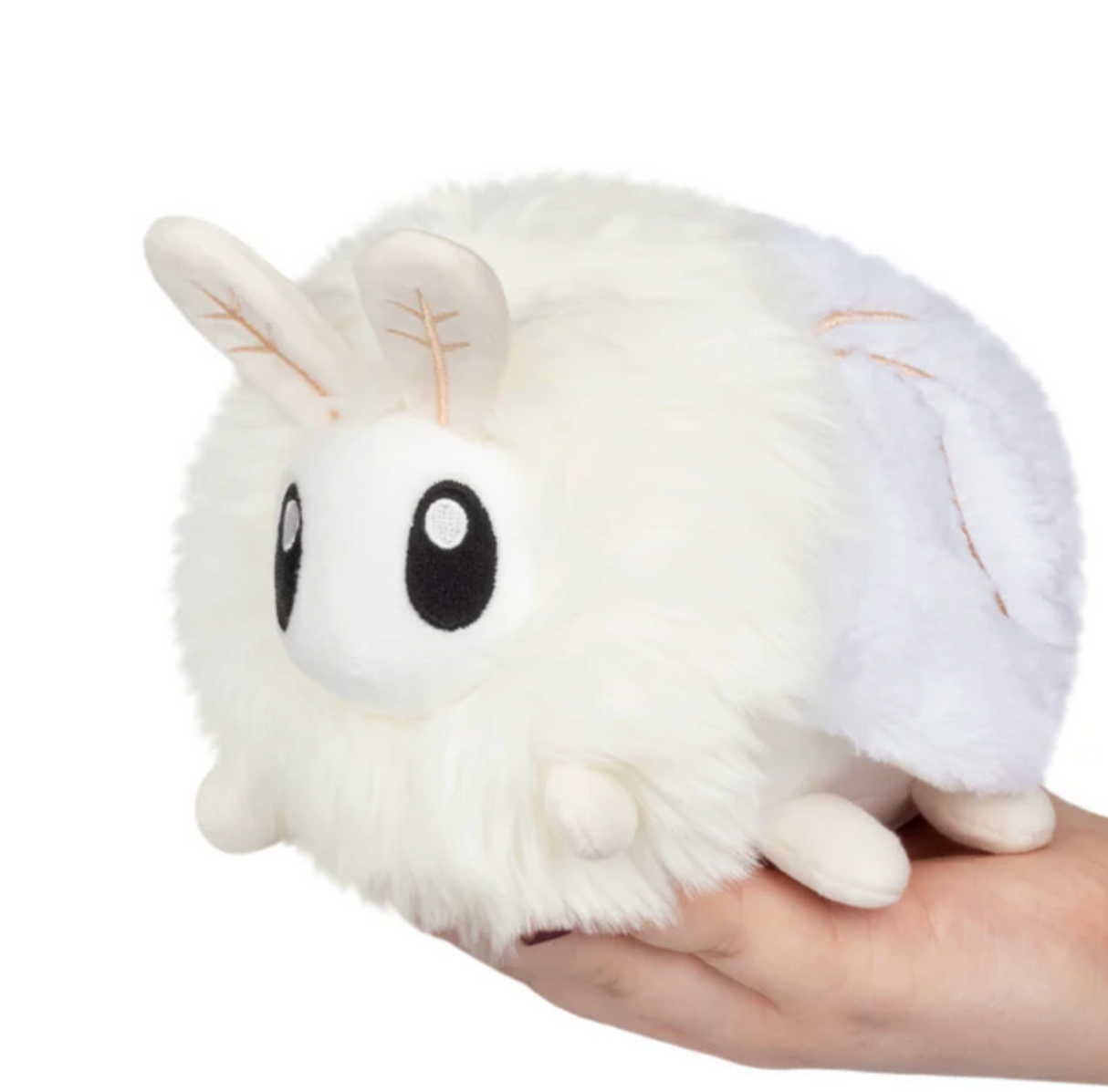 Hand holding fluffy white plush toy with big eyes and ears, Poodle Moth Snackers product.
