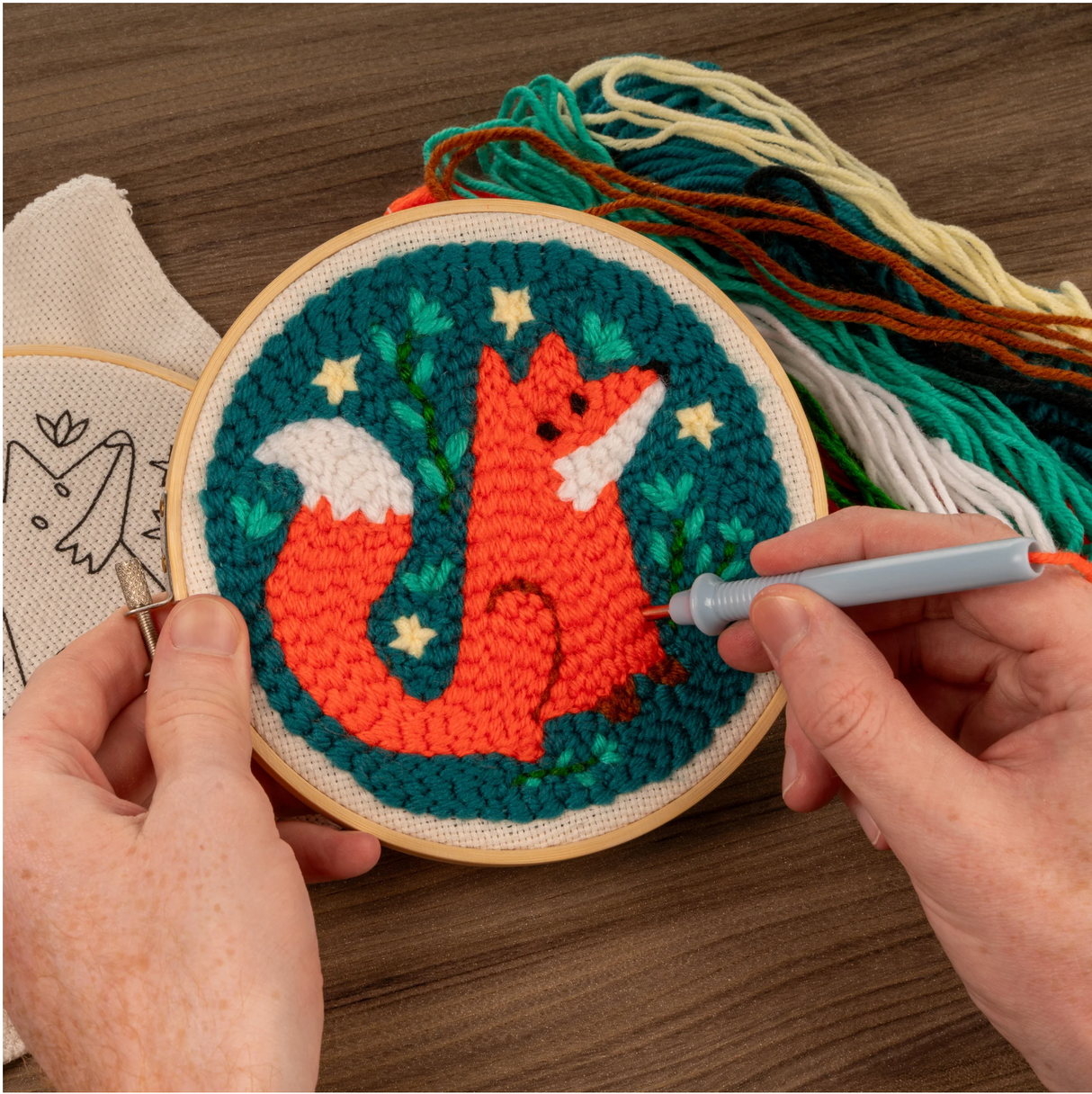 Punch Needle Kit | Fox showing detailed rug hooking of a vibrant fox in an adjustable bamboo hoop with yarn strands.