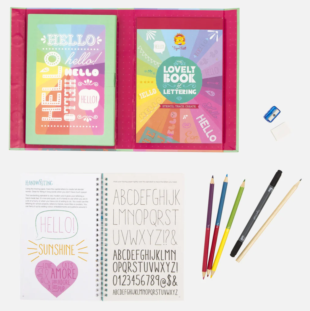The Lovely Book of Lettering kit with pencils, pen, eraser, sharpener, and stencil notebook for creative font design.