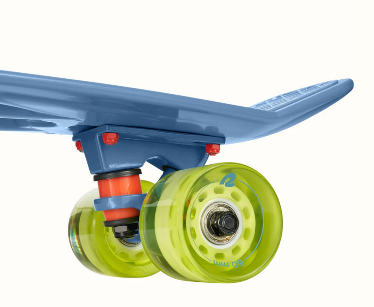 Close-up view of the wheel and truck of the Quip Mini Cruiser Skateboard in Marine Blue color.