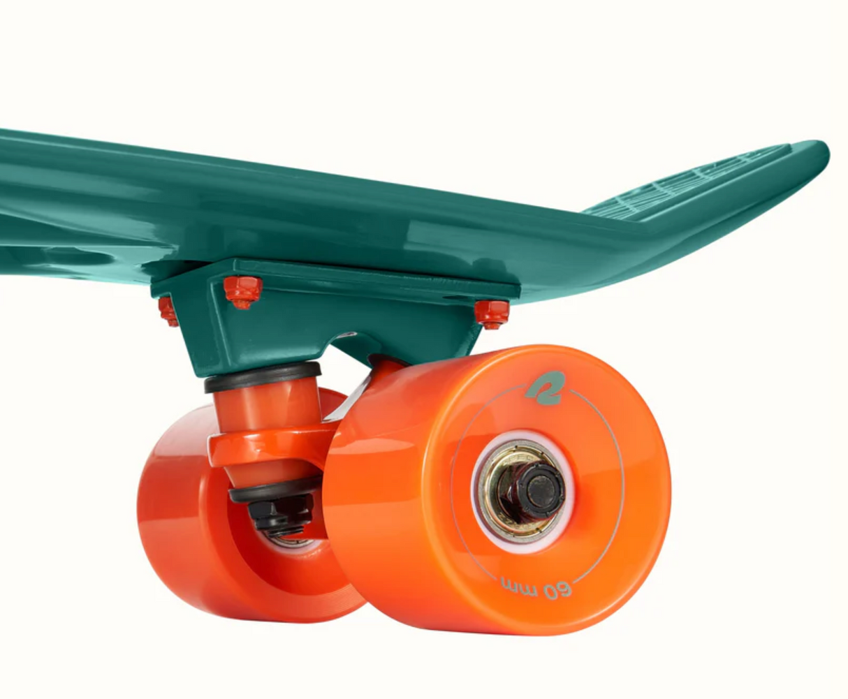 Close-up of orange wheels and teal deck trucks on the Quip Mini Cruiser Skateboard | Tropical Teal.
