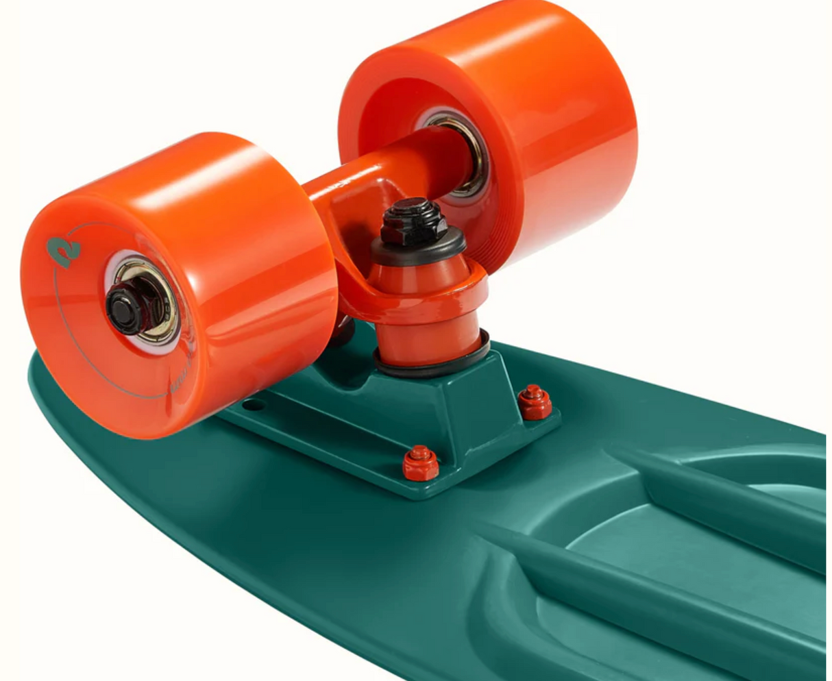 Close-up of Quip Mini Cruiser Skateboard Tropical Teal showing bright orange wheels and durable plastic deck design.