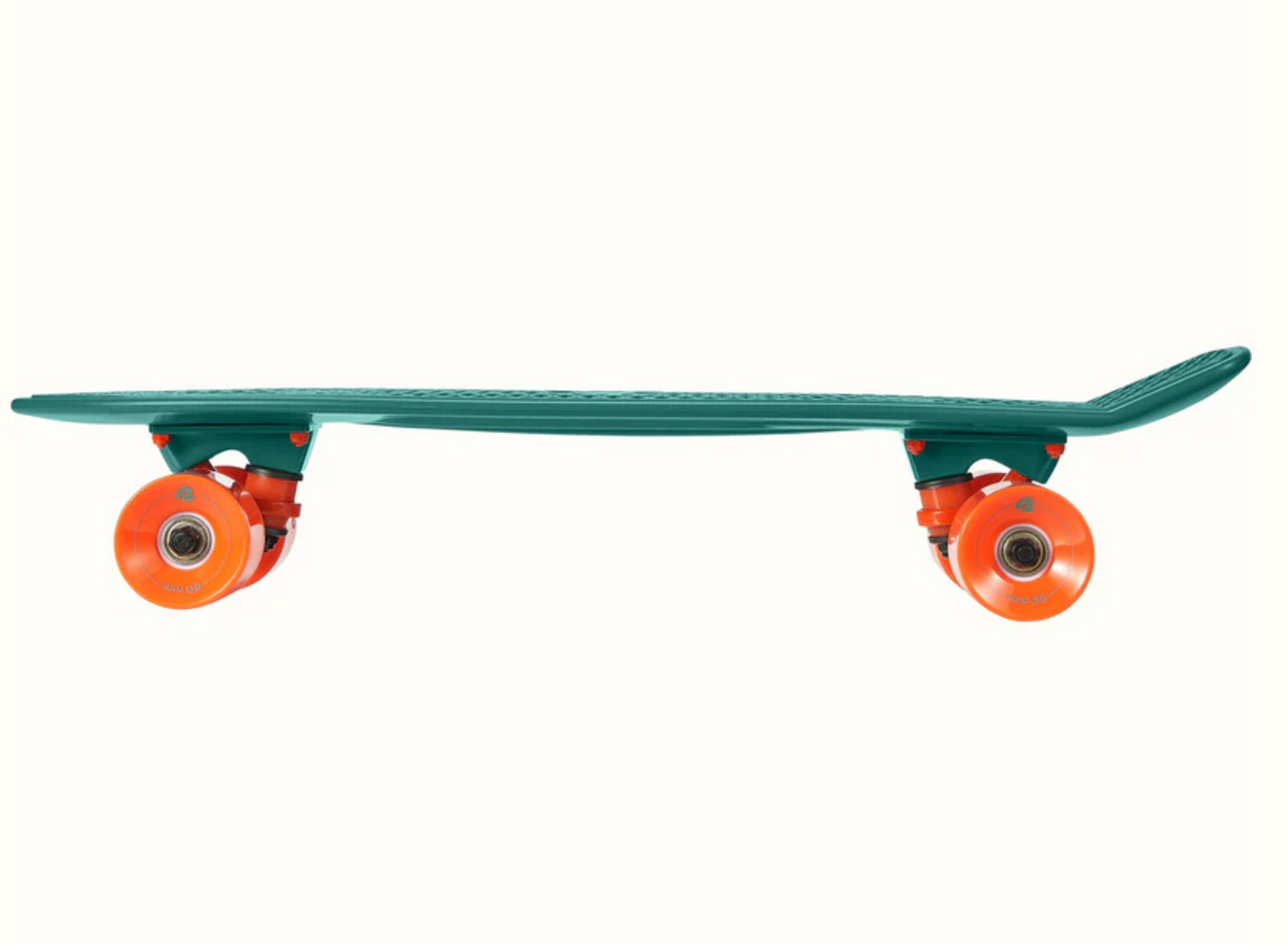 Quip Mini Cruiser Skateboard Tropical Teal side view showing durable plastic deck with bright orange wheels.