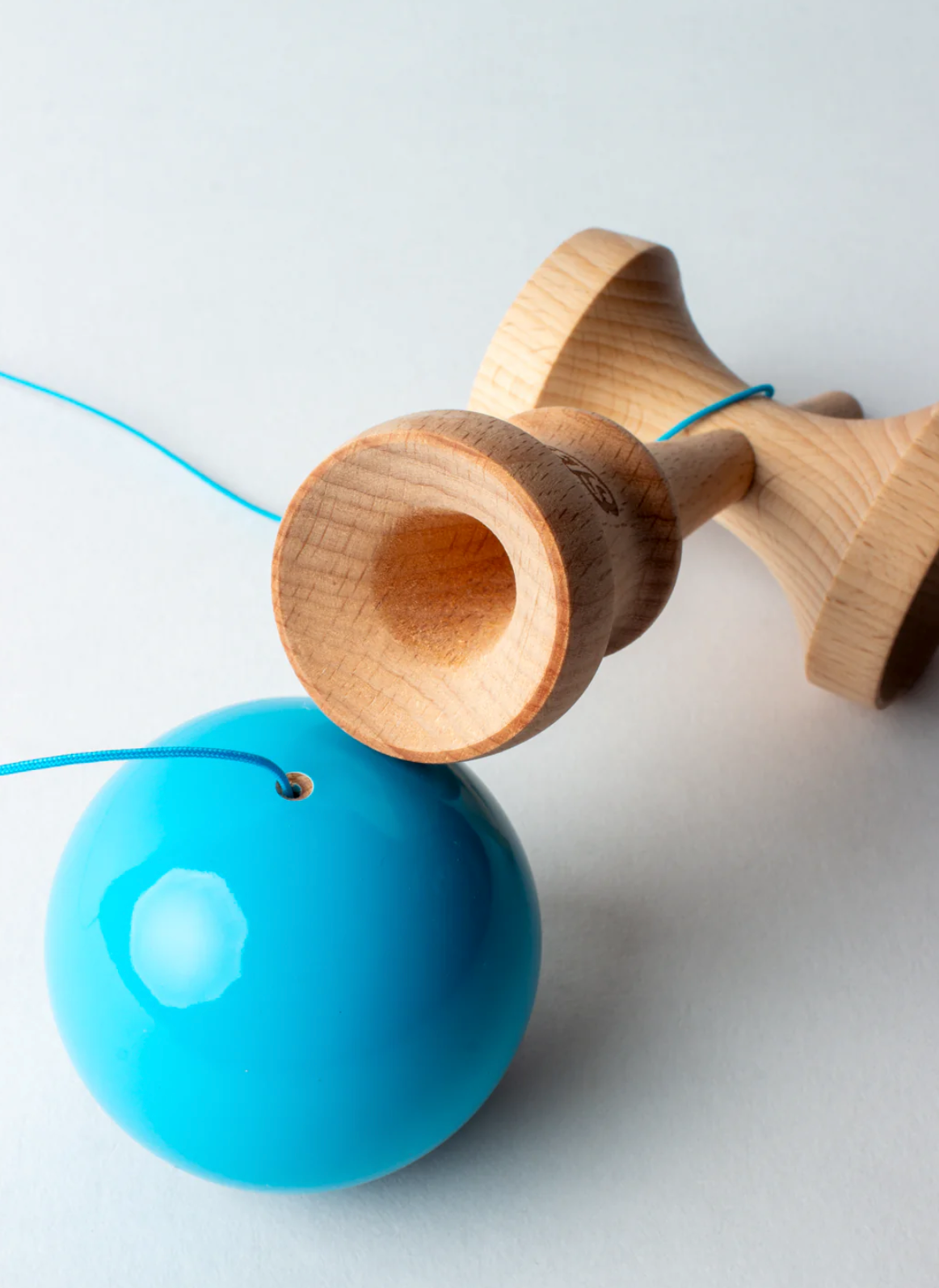 Kendama Prime Radar | Blue with wooden ken, sticky clear tama, and matching blue string on white background.