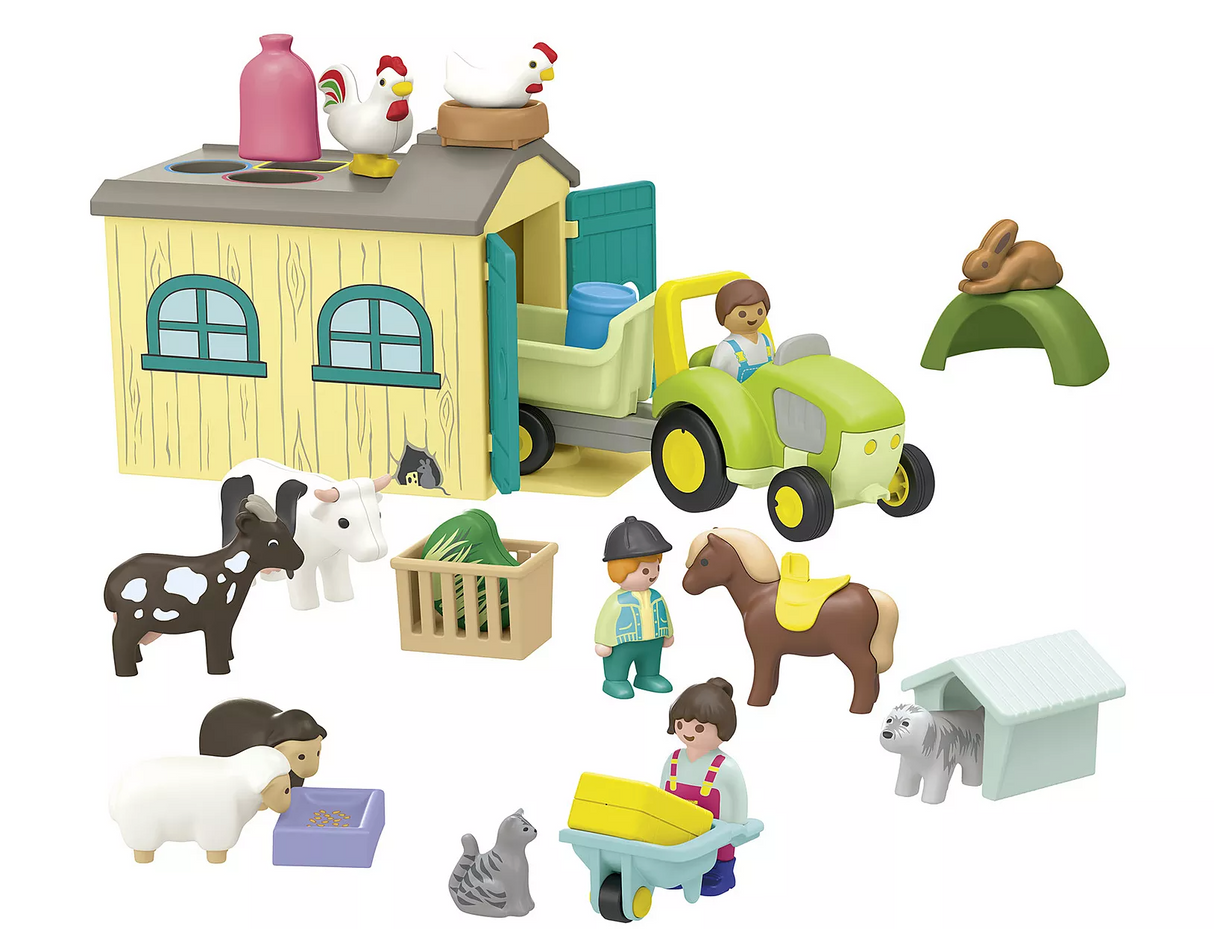 Junior | Farm Adventure with Tractor playset featuring farm animals, tractor with trailer, barn, and farm family figures.