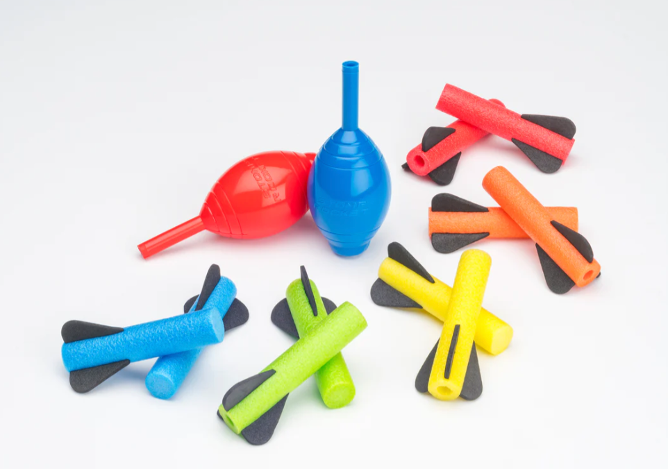Squeeze Rockets set showing colorful foam rockets and two hand-held squeeze launch bulbs on a white background.