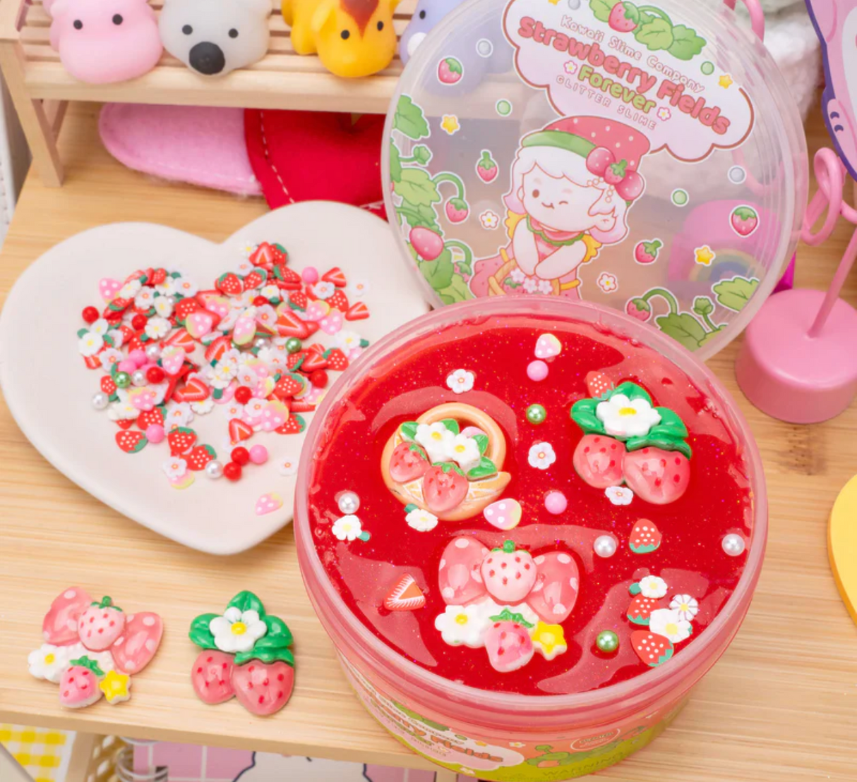 Strawberry Fields Forever Glitter Slime with chunky glitter and strawberry charms in bright red, thick and stretchy texture.