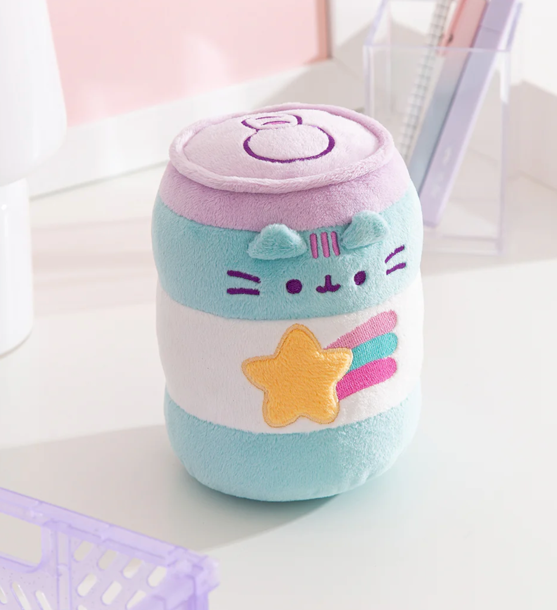 Pusheen Gamer Pop Sip plush in blue and white with embroidered face and yellow shooting star accent on white background.