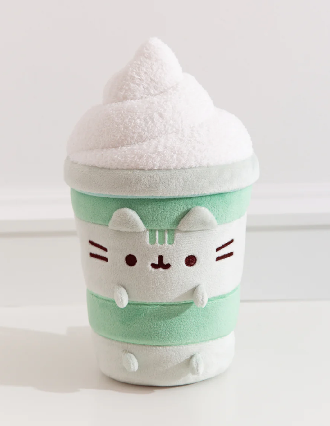 Pusheen Matcha Latte plush featuring a green matcha cup with white whipped foam and Pusheen’s signature smile and ears.
