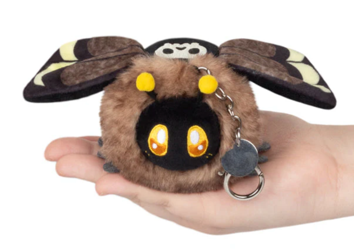 Soft plush toy of Death's Head Hawkmoth Micro with keychain, held in a hand showing its small size.