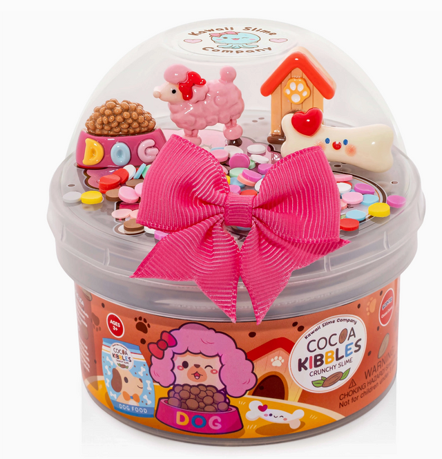Clear container of white crunchy slime with colorful sprinkles and pet-themed charms including a pink poodle and dog house