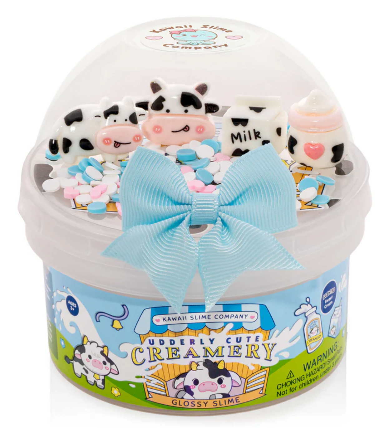Glossy white slime with cow, milk carton, and bottle charms in a decorated container with a blue bow