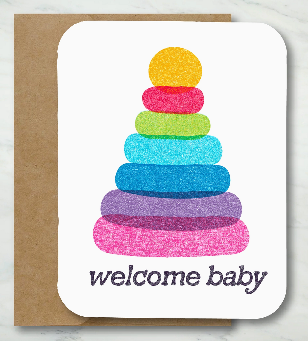 Welcome baby card with colorful stacked rings design on textured white cardstock and recycled kraft envelope