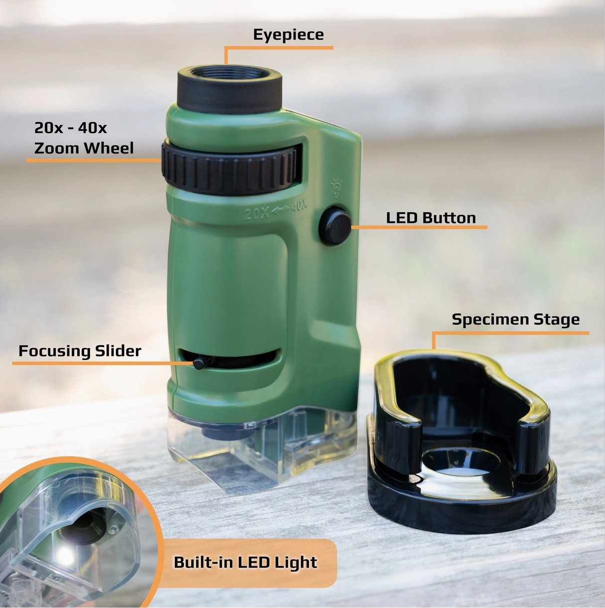 Compact green pocket microscope with adjustable zoom, LED light, focusing slider, and removable specimen stage on wooden surface