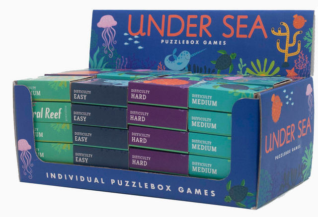 Display box of colorful sea creature puzzleboxes with easy, medium, and hard difficulty levels for individual games