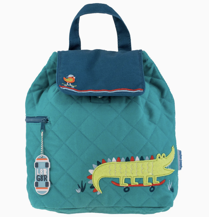 Teal quilted backpack with embroidered alligator on skateboard and bird detail on flap closure