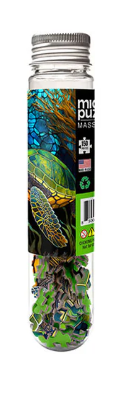 Clear tube packaging showing stained glass sea turtle 150-piece micro puzzle with ocean background design