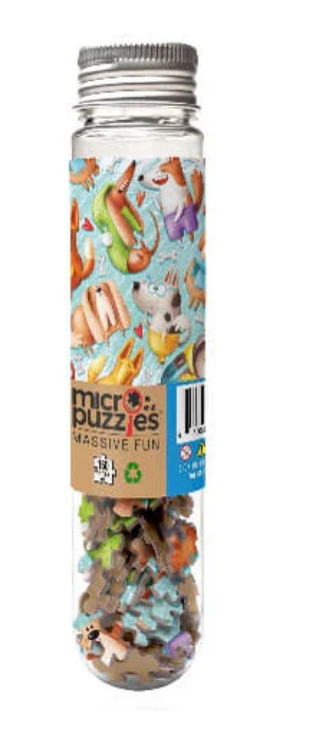 Clear tube containing colorful micro puzzle pieces with playful dog illustrations on the label and silver cap.