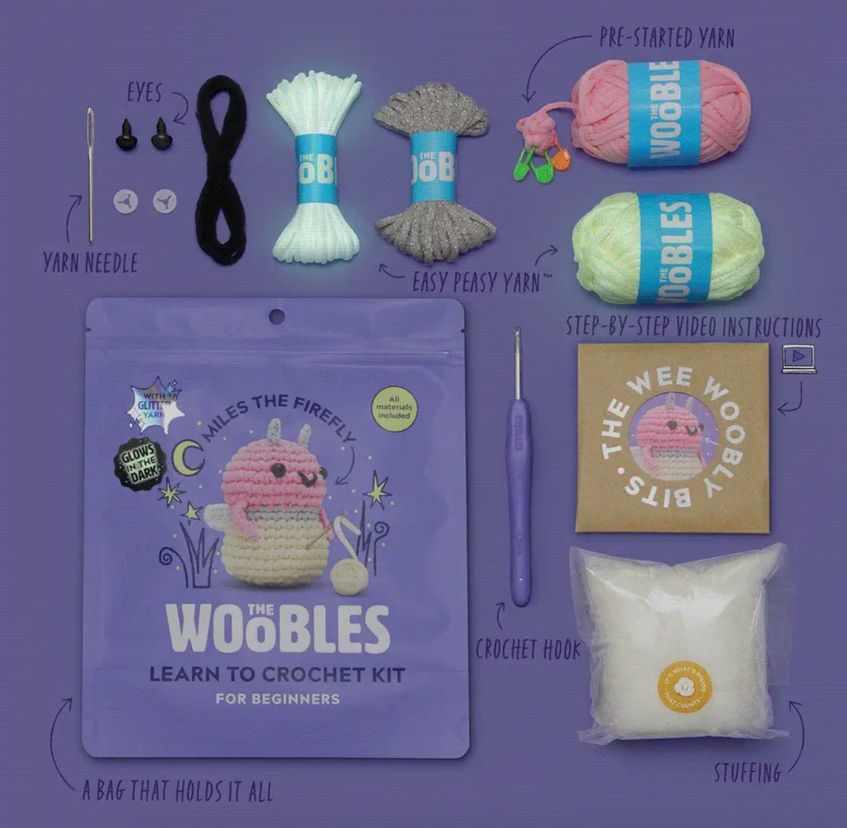 Complete crochet kit for beginners featuring glow-in-the-dark pink and cream yarn with tools and instructions laid out on purple background