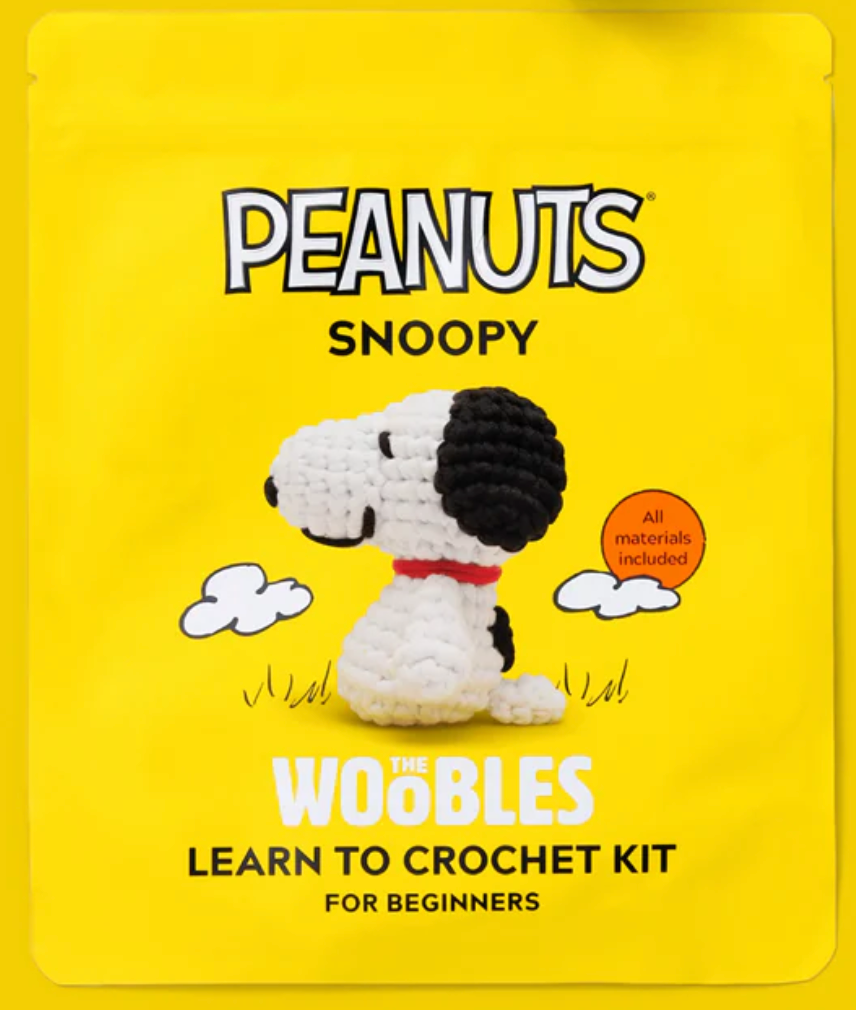 Yellow packaging featuring a crocheted Snoopy figure with black ears and red collar for beginner crochet kit.
