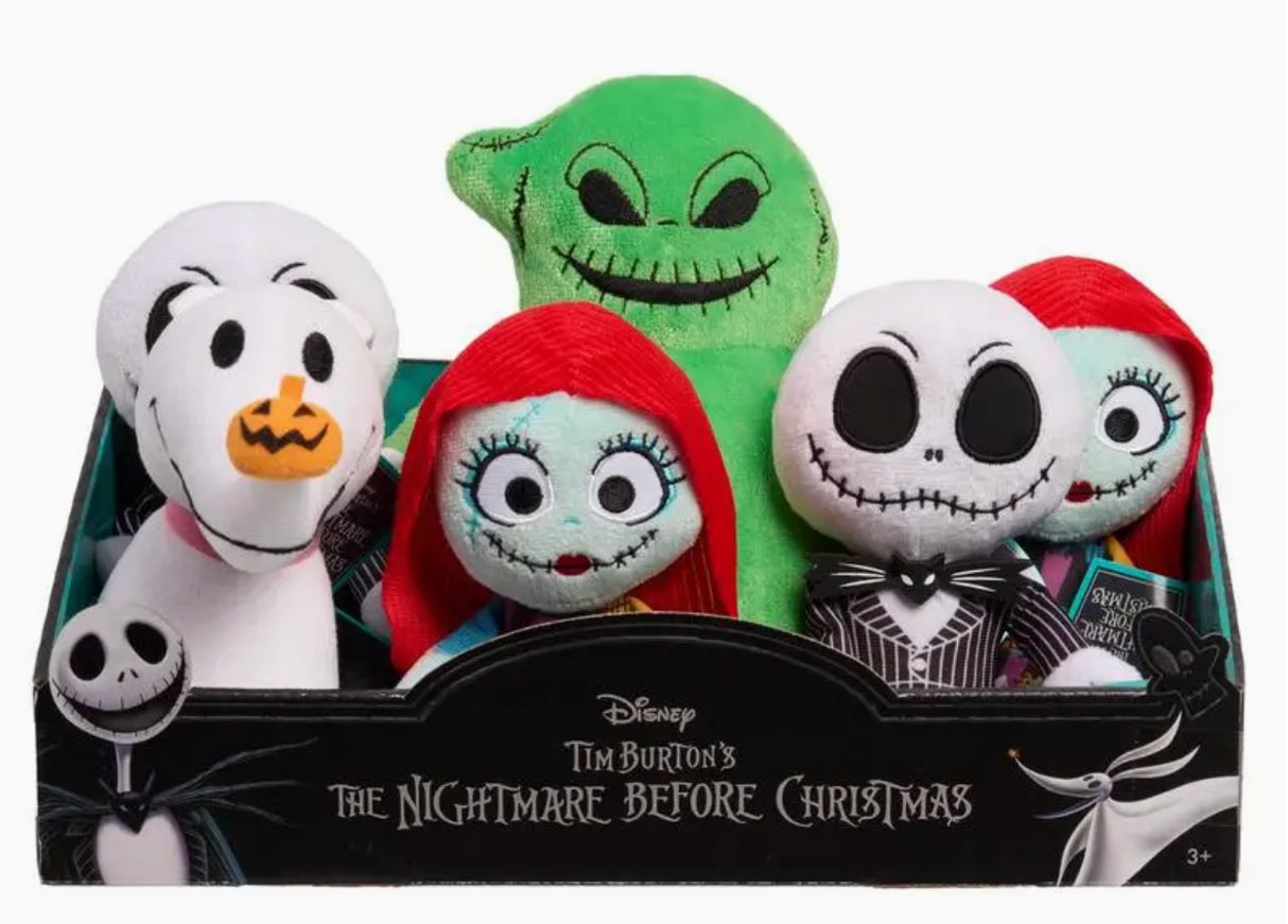 Assorted plush characters from The Nightmare Before Christmas, including Jack Skellington and Sally, in a display box.