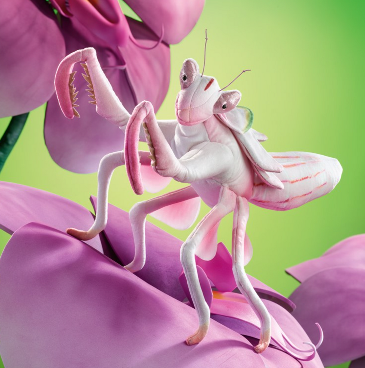 Delicate pink and white Orchid Mantis puppet perched on a vibrant flower with articulated legs for lifelike movement