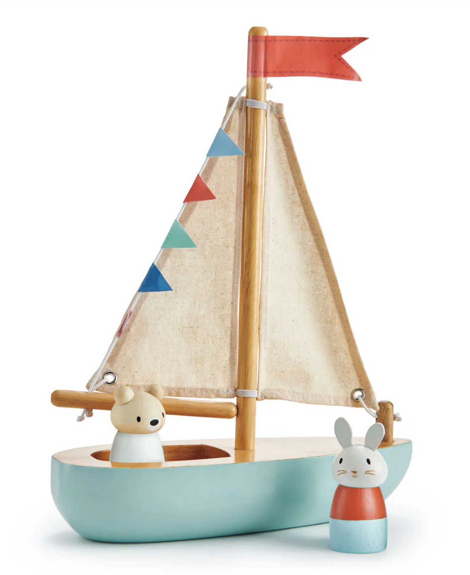 Wooden sailboat toy with cream fabric sails, colorful bunting, and two cute animal figures Bubble and Squeak nearby