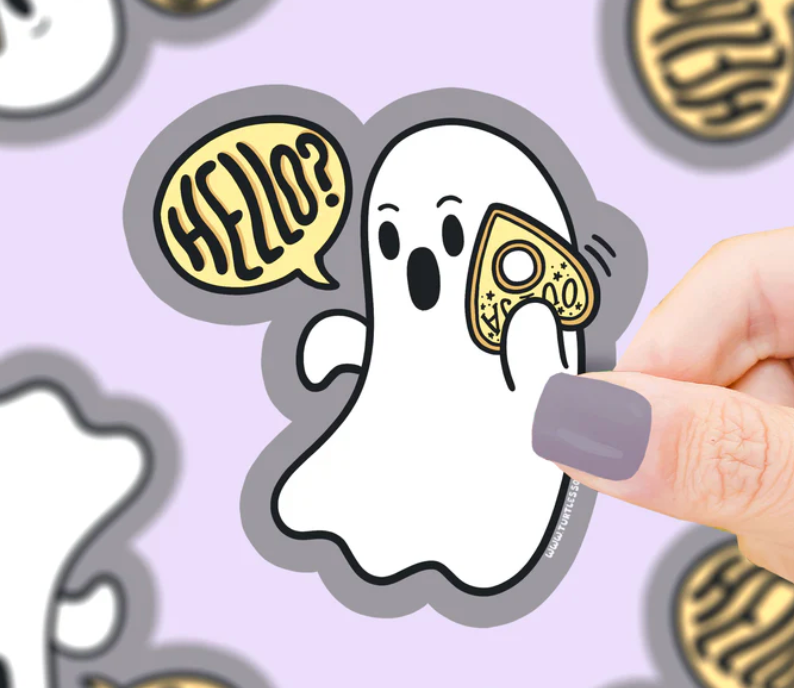Hand holding Ghost Planchette Call Sticker featuring a friendly ghost saying hello with a spirit board planchette phone.