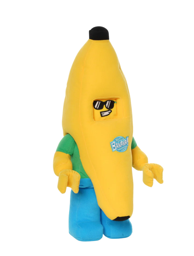 Soft plush figure of a smiling banana character wearing sunglasses with green shirt and blue pants standing upright