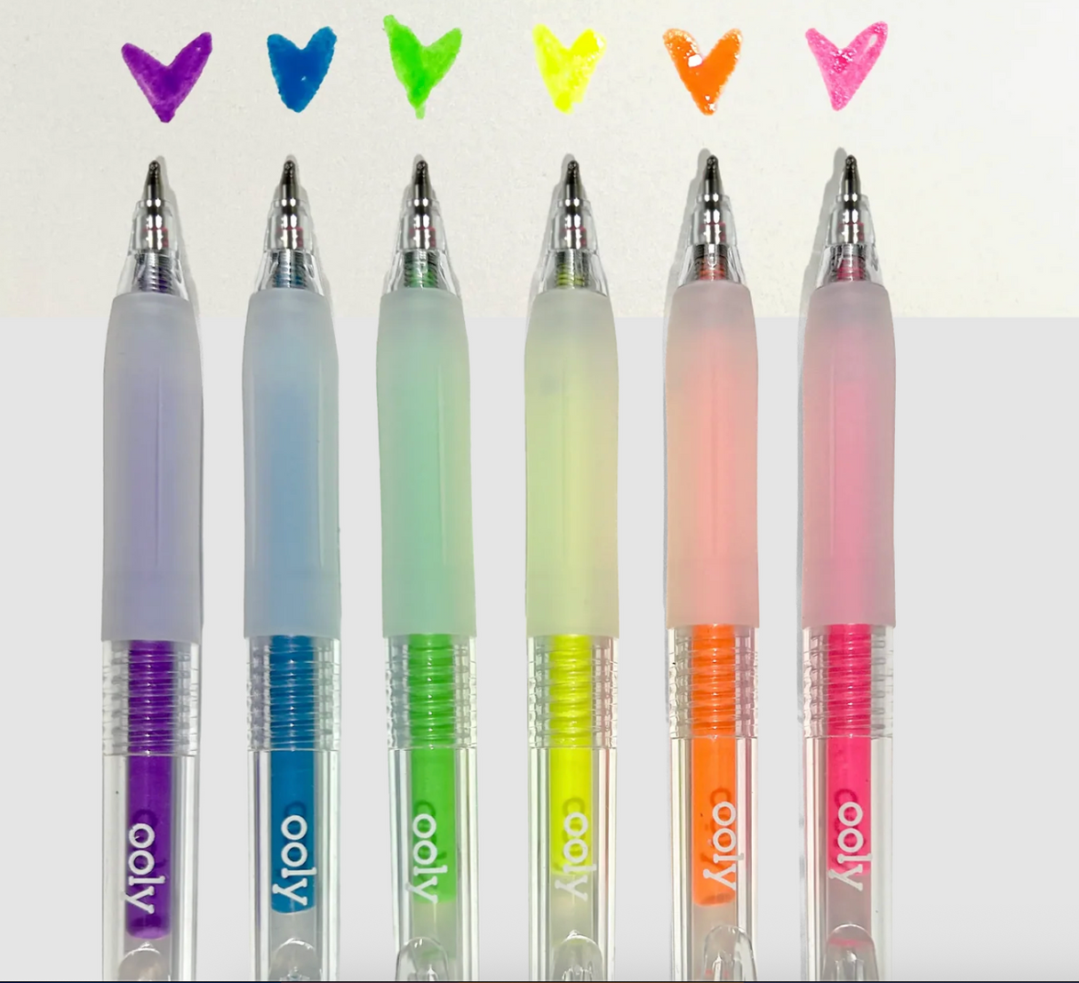 Set of six neon gel pens with colorful heart designs showing glossy, raised ink effects on paper.