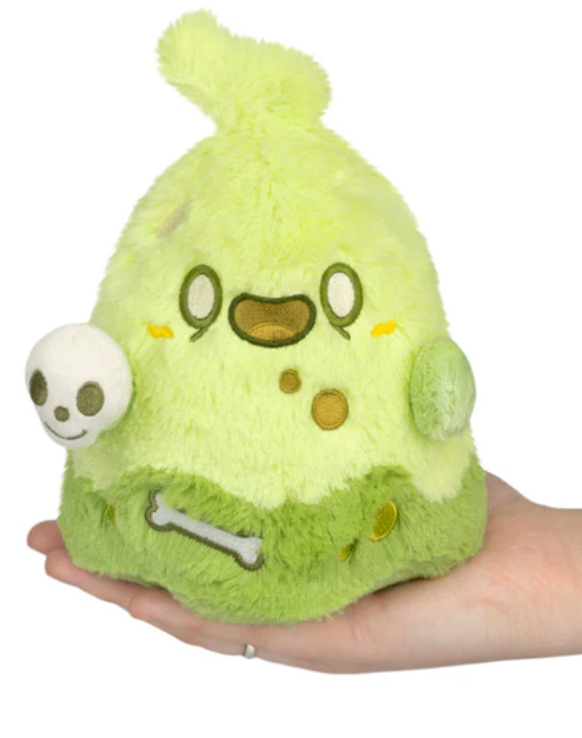 Soft bright green slime ghost plush with friendly face holding a small skull, fitting comfortably in a hand.
