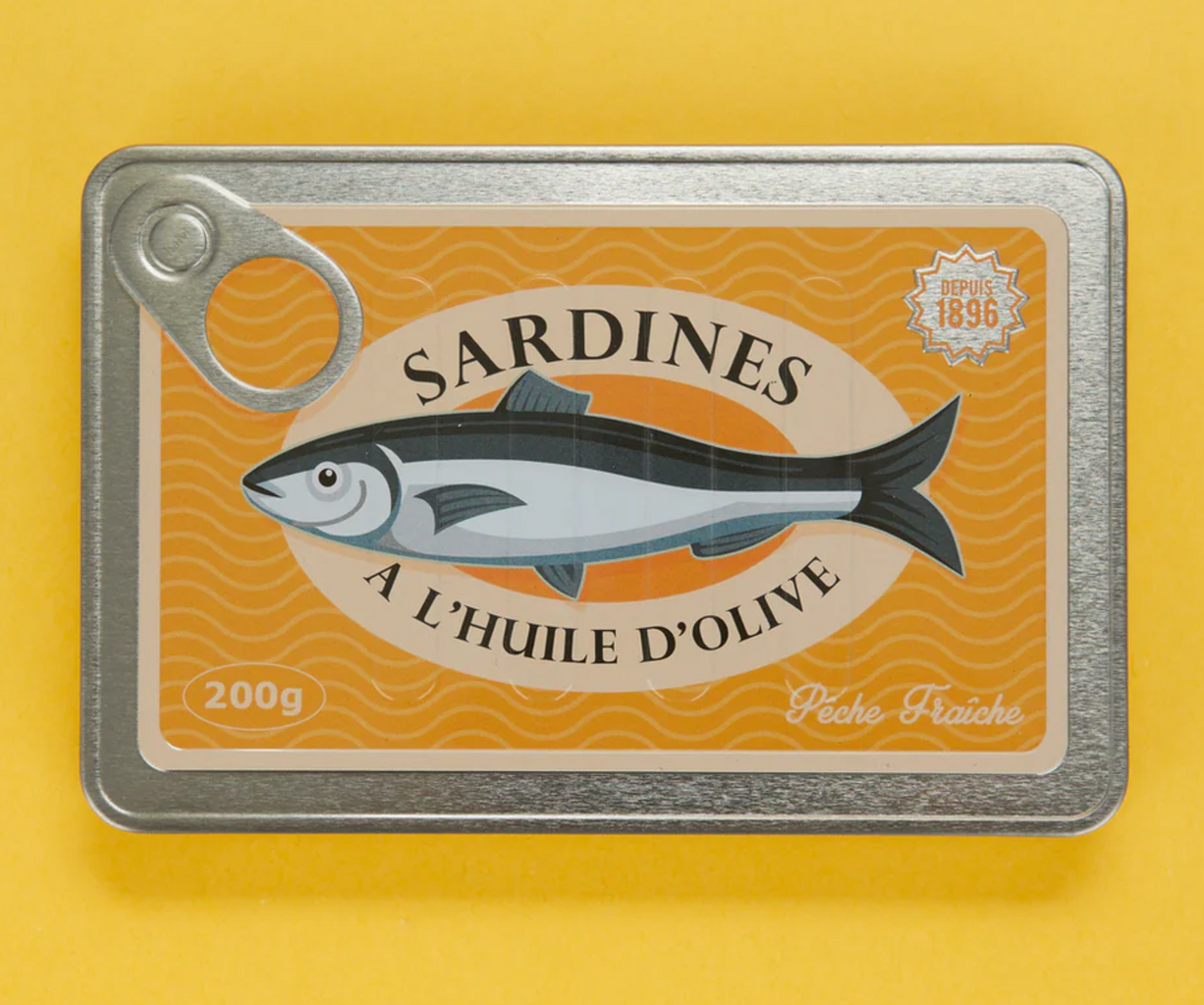 Vintage sardine tin-style notebook with textured metal cover and playful olive oil design on yellow background