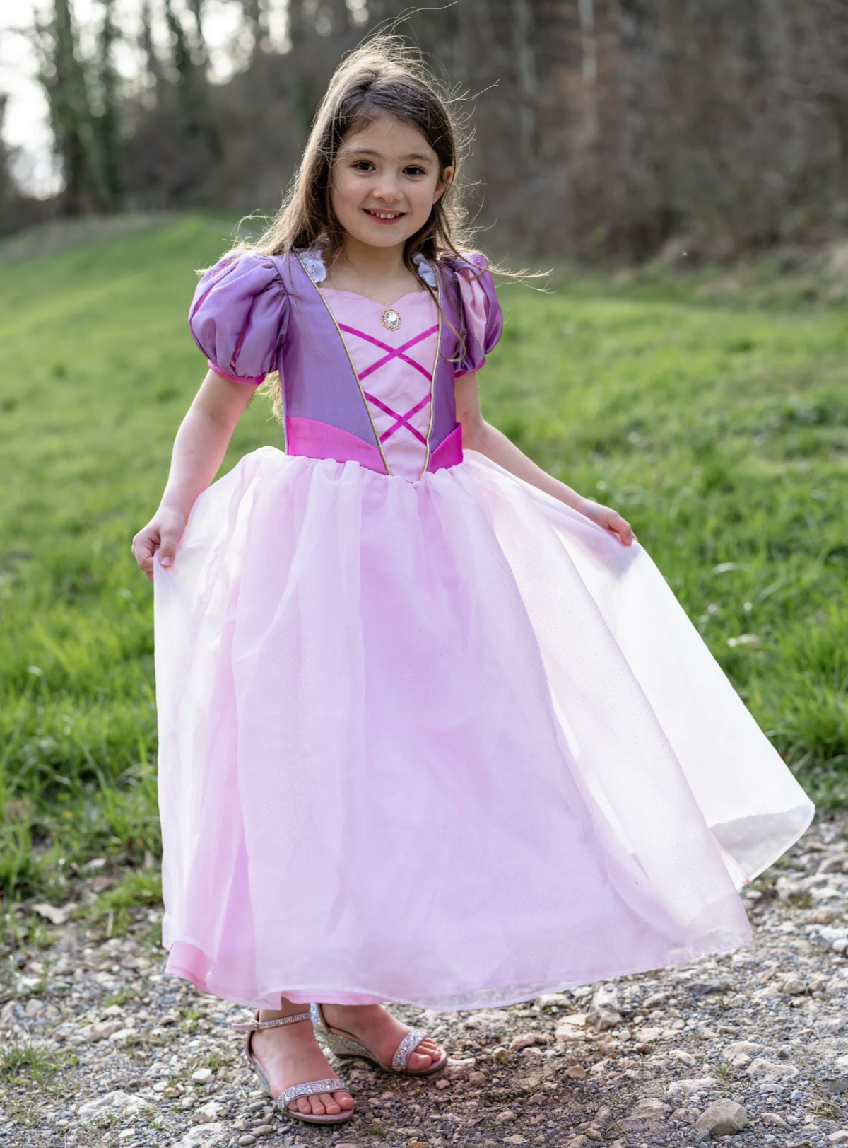 Velvety Soft Once Upon A Tower Princess Gown | Size 7-8 worn by a smiling child outdoors