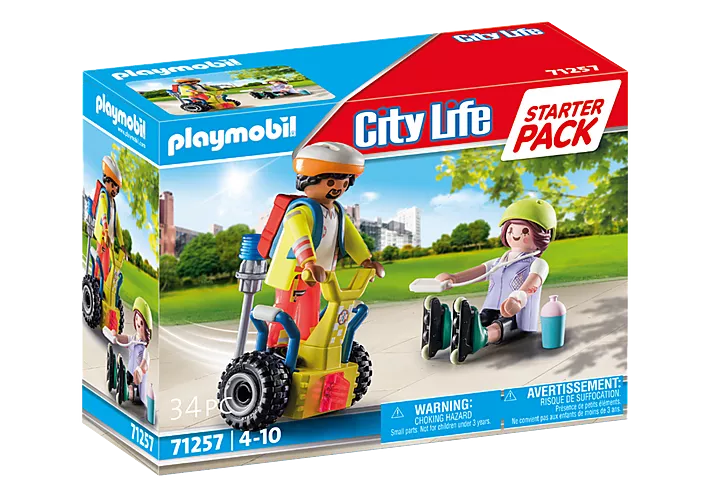 City Life | Rescue with Segway showing paramedic on balance racer aiding fallen inline skater in park setting.
