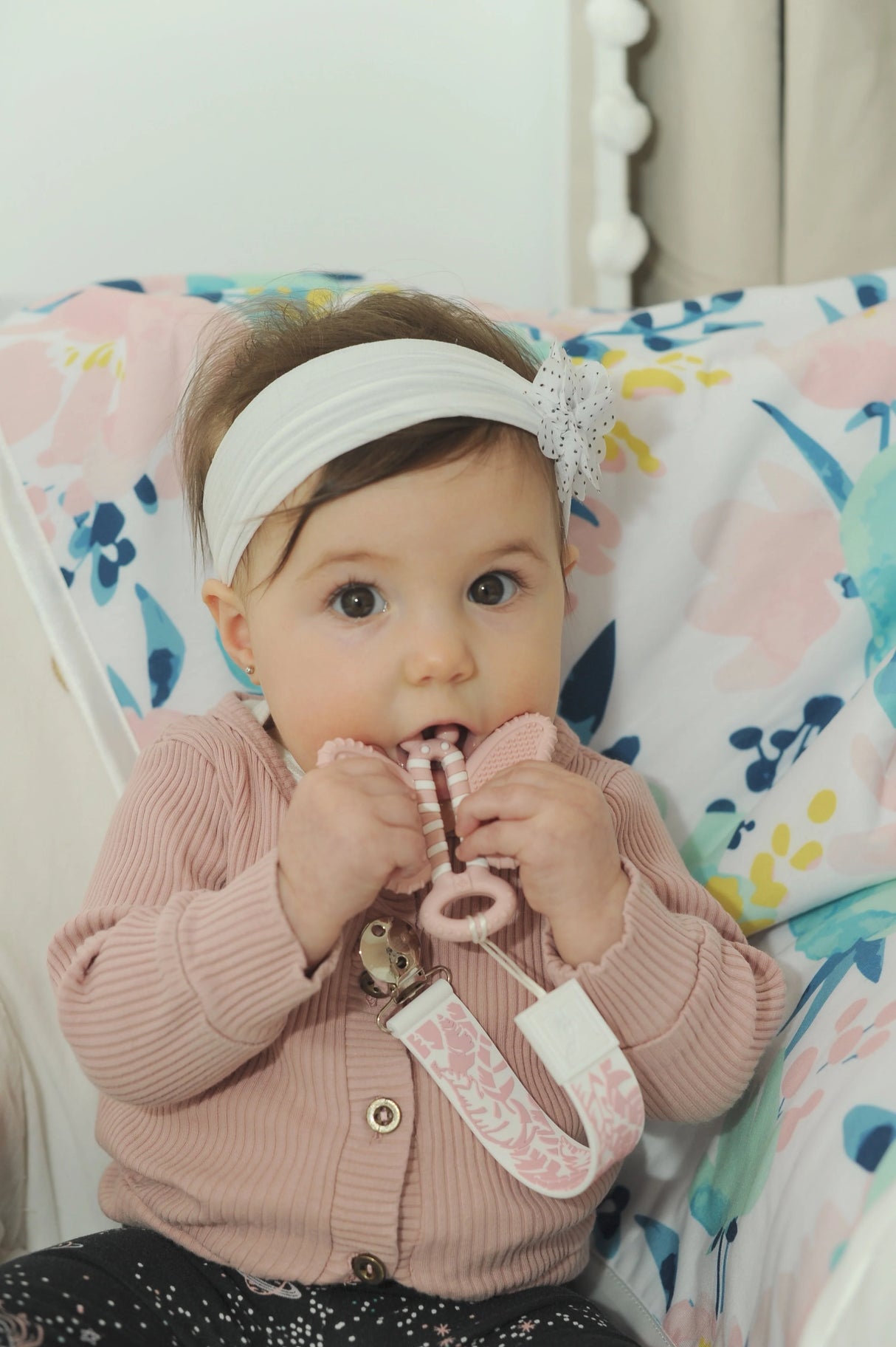 Baby using the Toothbrush Teether | Butterfly Brush designed for soothing and cleaning gums safely.