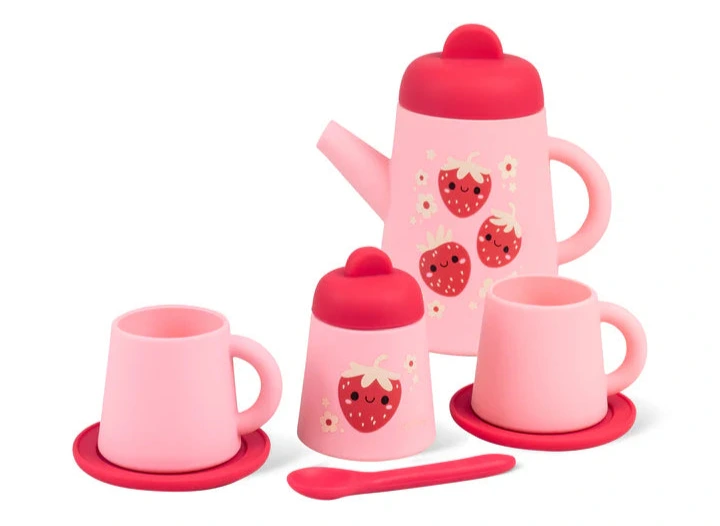 Strawberry Patch Silicone Tea Set with teapot, cups, saucers, sugar bowl, and spoon in pink with strawberry design.