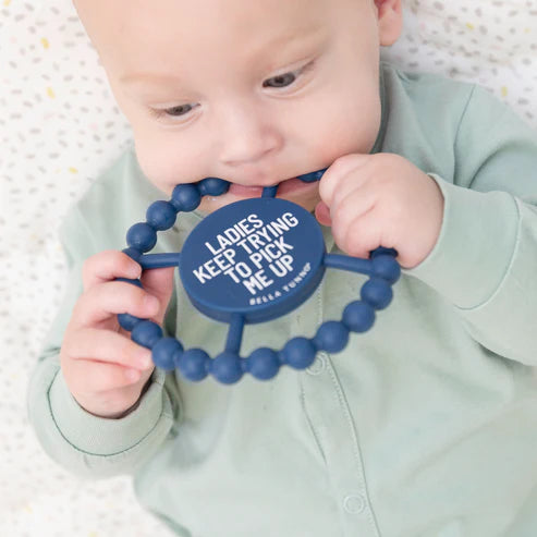 Baby chewing on a navy silicone teether with textured beads for relief, called Teether | Ladies Pick Me Up.