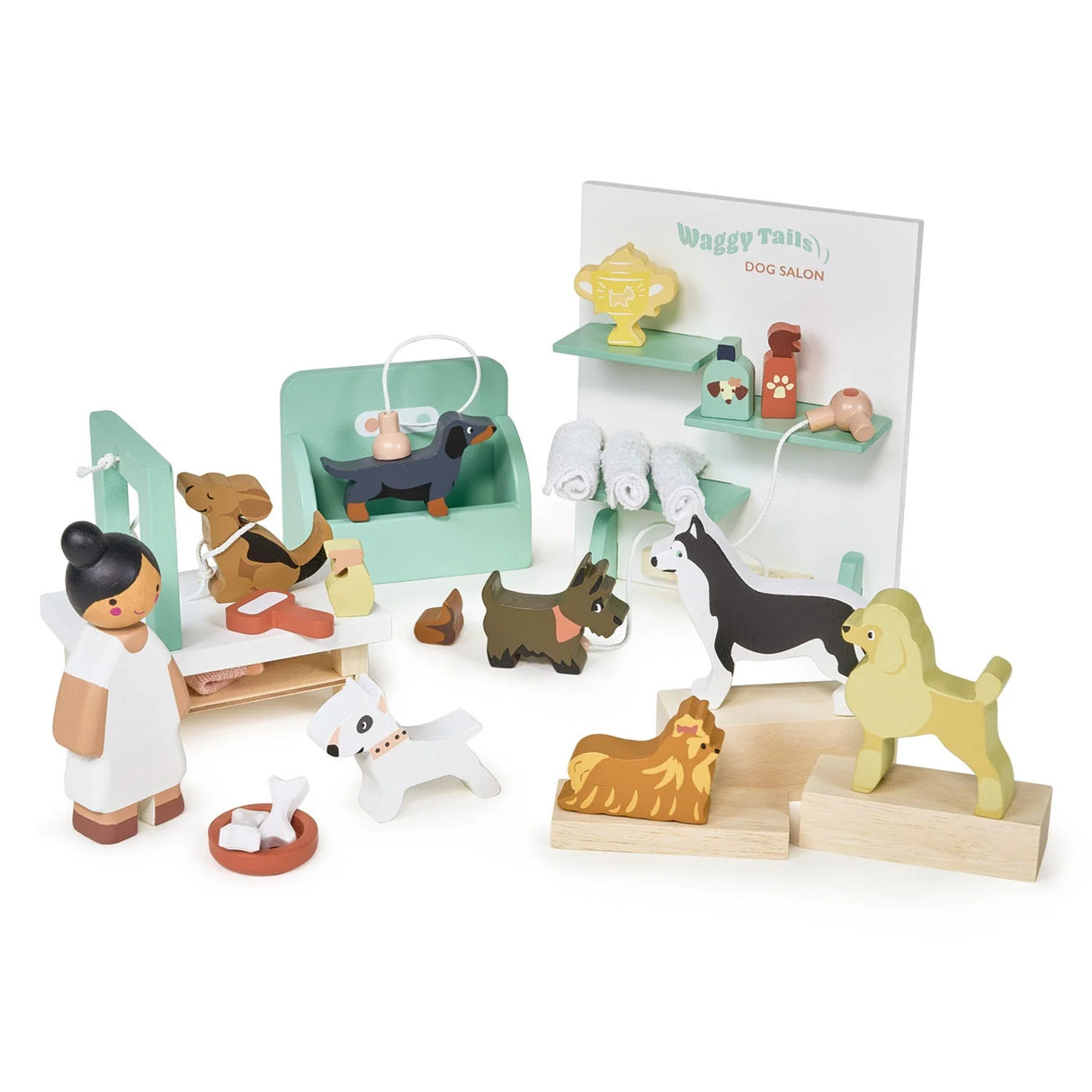 Waggy Tails Dog Salon play set with lady groomer, seven dog breeds, grooming table, towels, and accessories.