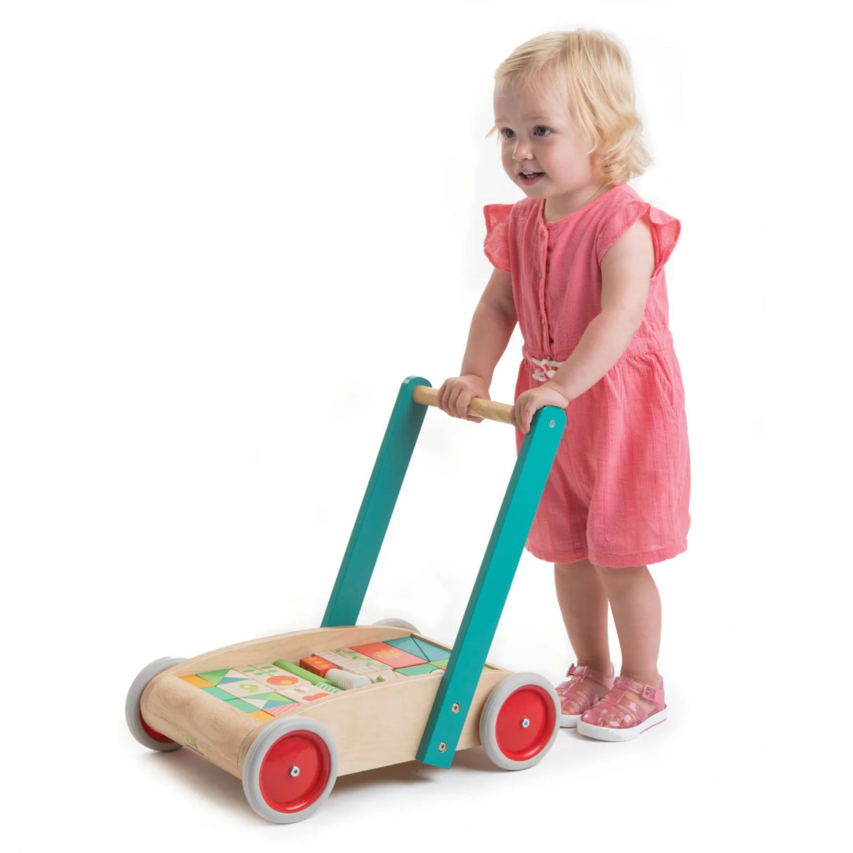 Toddler using a wooden Baby Block Walker with colorful blocks, designed to support first steps and creative play.