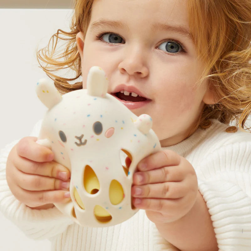 Child holding a soft Silicone Rattle | Bunny made of safe, food-grade silicone with gentle rattle sound inside.