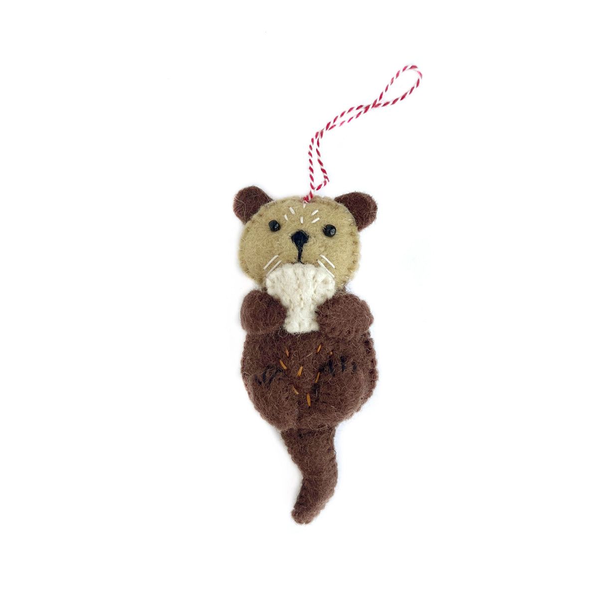 Handmade felt otter ornament in brown and tan wool with stitched details and red striped hanging loop