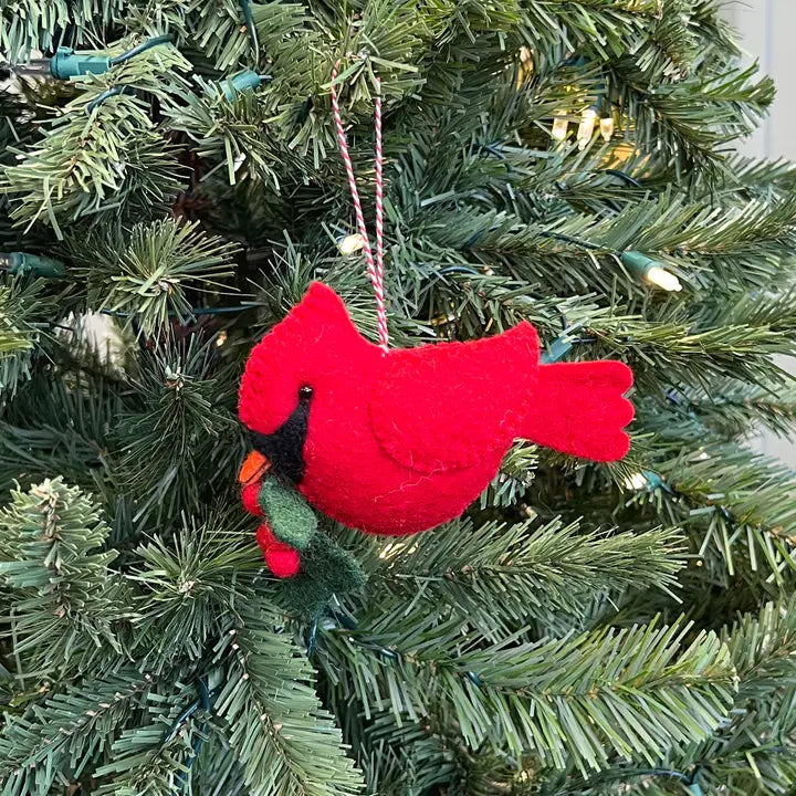 Cardinal with Holly Felt Ornament hanging on a Christmas tree, handmade red felt bird with green holly leaves and berries.