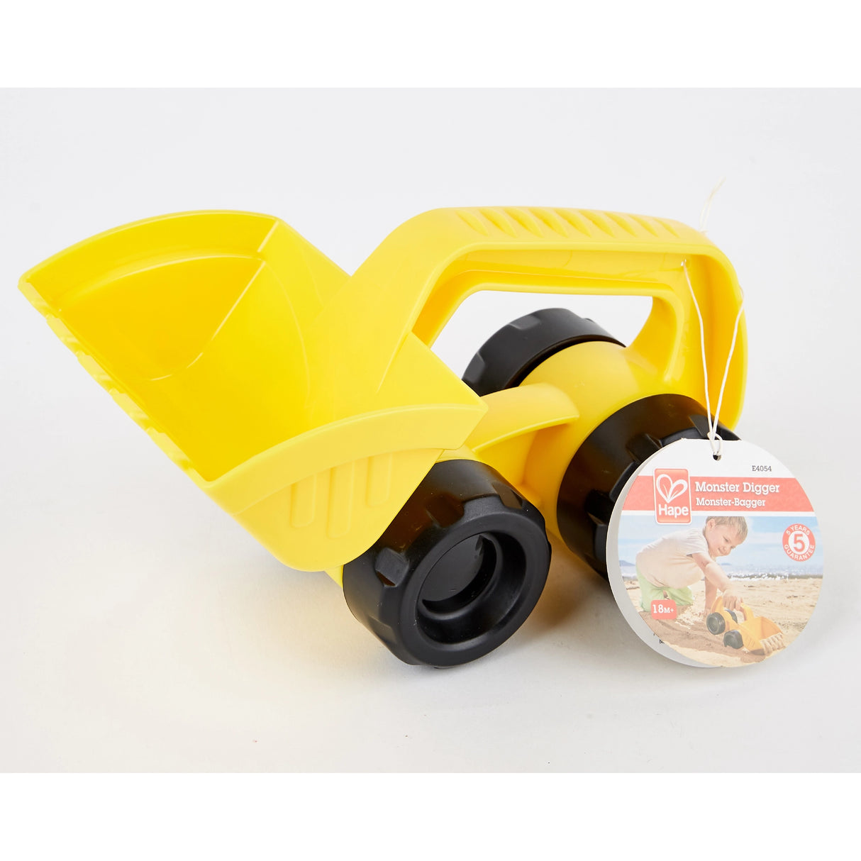 Small yellow toy digger with black wheels and handle designed for sand or outdoor play
