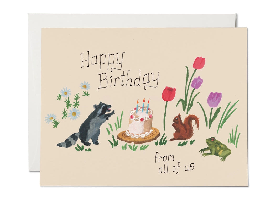Birthday card featuring raccoon, squirrel, frog, flowers, and a birthday cake with candles on beige background