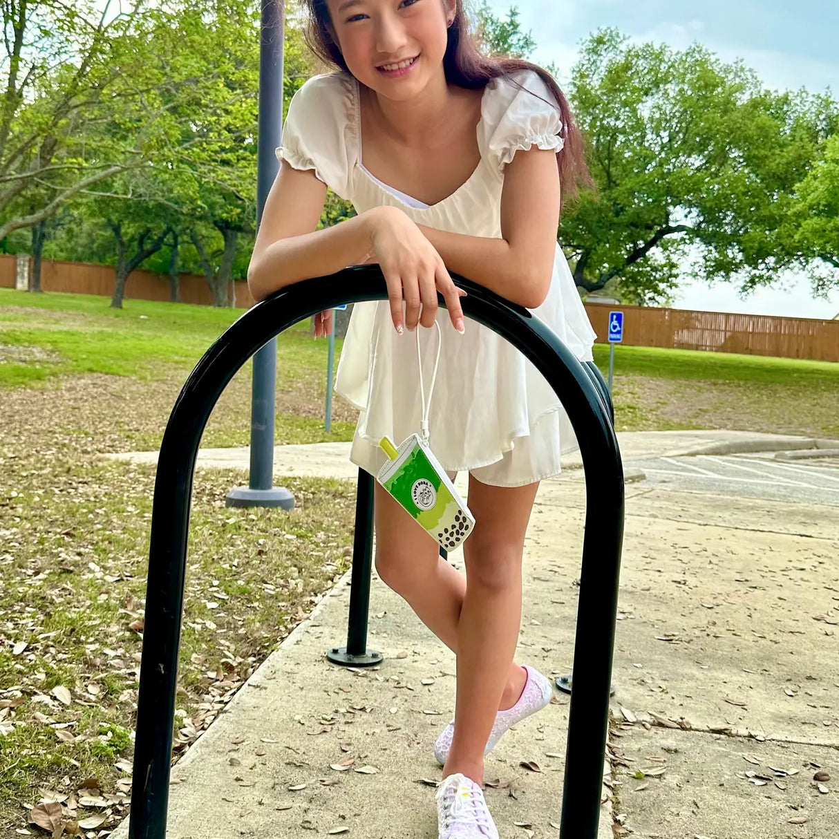 Wristlet | Matcha Boba Milk Tea held by girl outdoors, cute and compact grab-n-go wallet for standard cards.