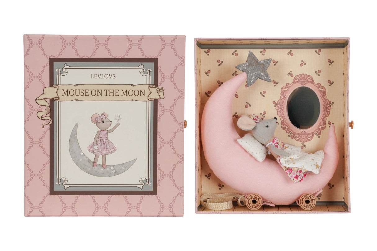 Cozy mouse doll resting on a pink crescent moon bed with a star, packaged in a decorative box for children.