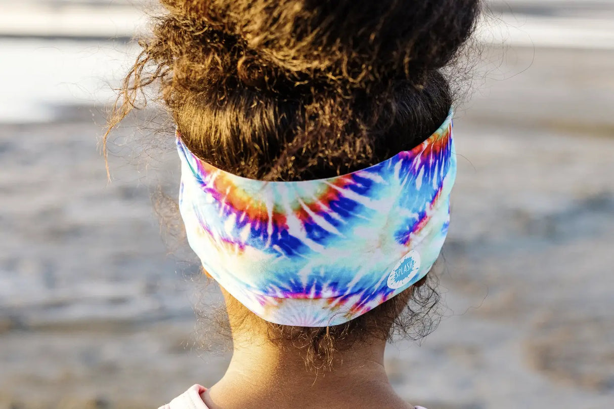 Goggles Tie Dye showing vibrant tie dye strap worn on back of head with curly hair in outdoor setting.